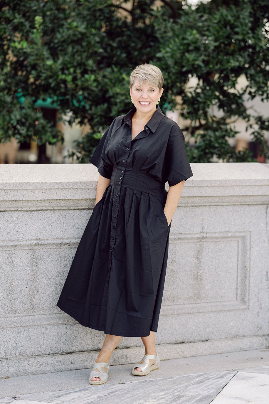 full body shot of Leigh Hayward in black dress