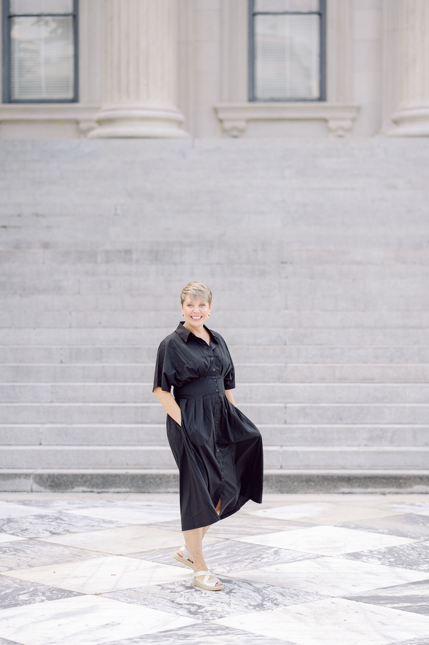 full body shot of photographer with hands in pockets