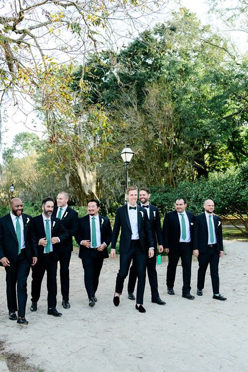 Groomsmen and groom walking path in Hampton Park