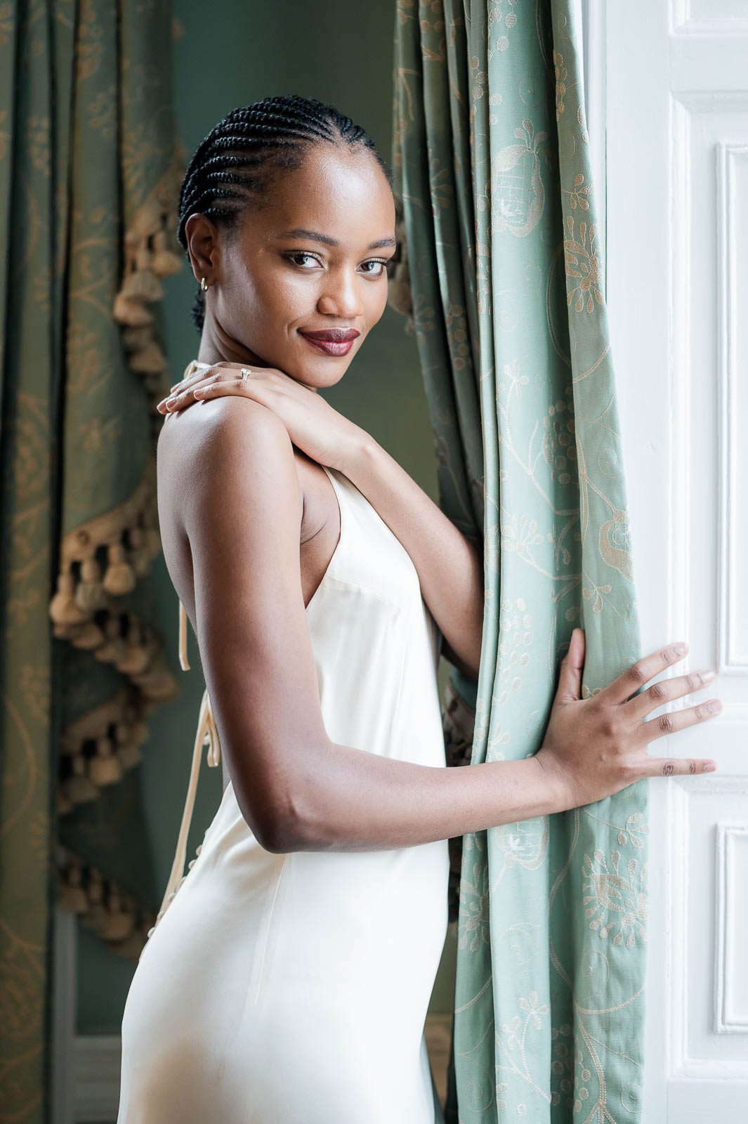 Bridal portrait of a bride standing near window at Lowndes Grove in Charleston, South Carolina,