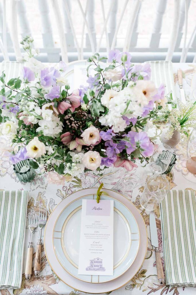 Pastel wedding place setting at The Parsonage in Charleston, South Carolina, featuring soft-toned linens, elegant tableware, and refined reception details