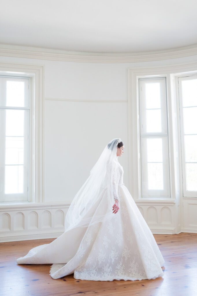 bride walking across room in long sleeve lace wedding dress at La Banquette Charleston SC