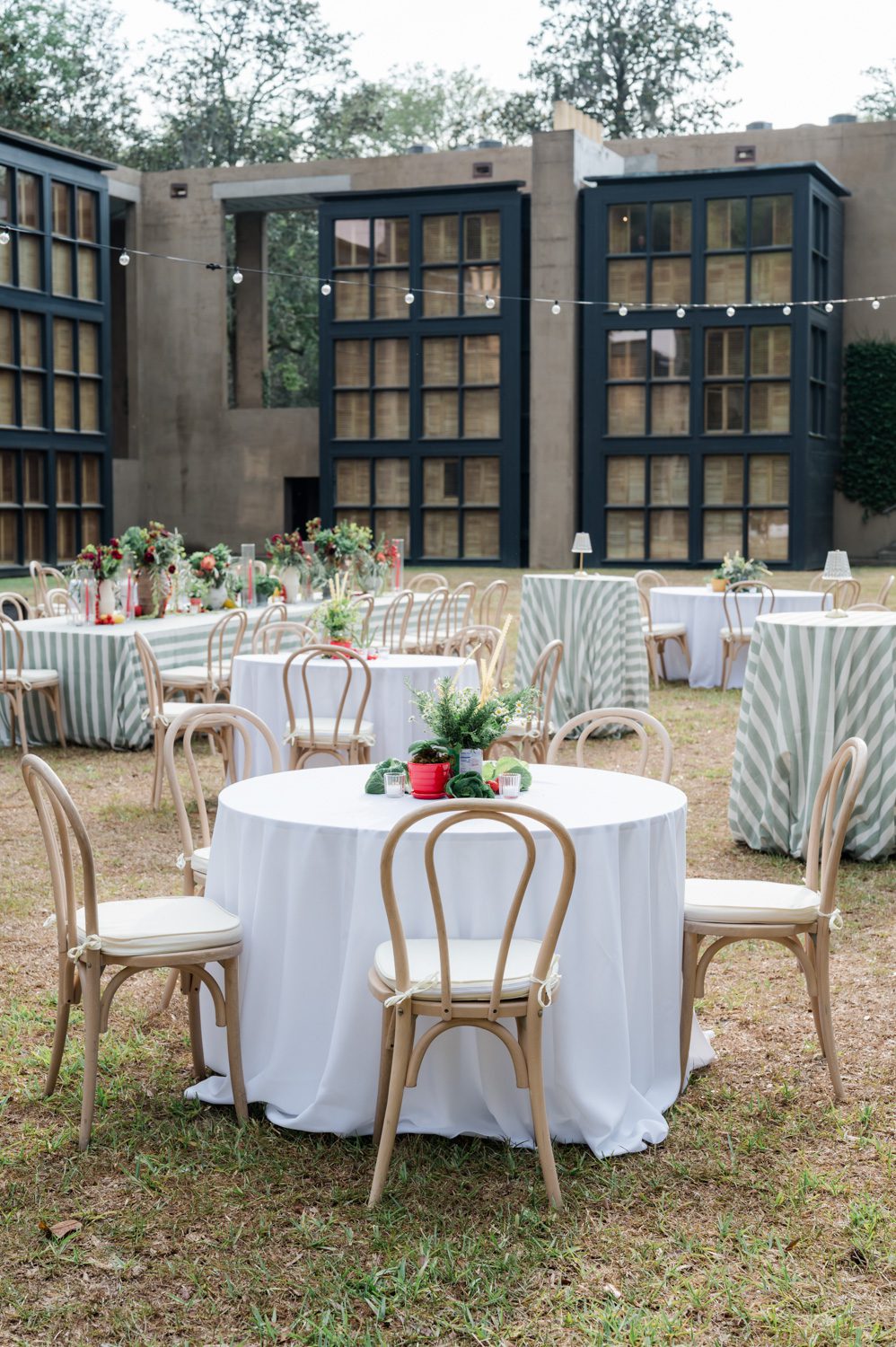 Italian-themed rehearsal dinner at Middleton Place Inn featuring elegantly styled long tables, warm candlelight, abundant florals, and an intimate multi-day wedding weekend celebration with refined Southern ambiance and Mediterranean-inspired details.