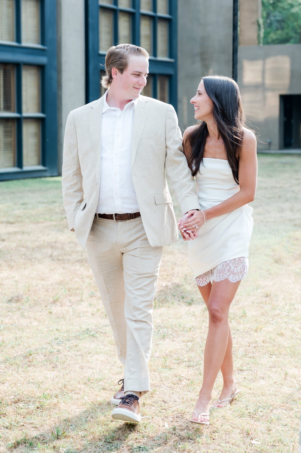 Engaged couple walking into an Italian-themed rehearsal dinner at Middleton Place Inn, part of a multi-day wedding weekend, with warm evening ambiance and elegant destination wedding styling.