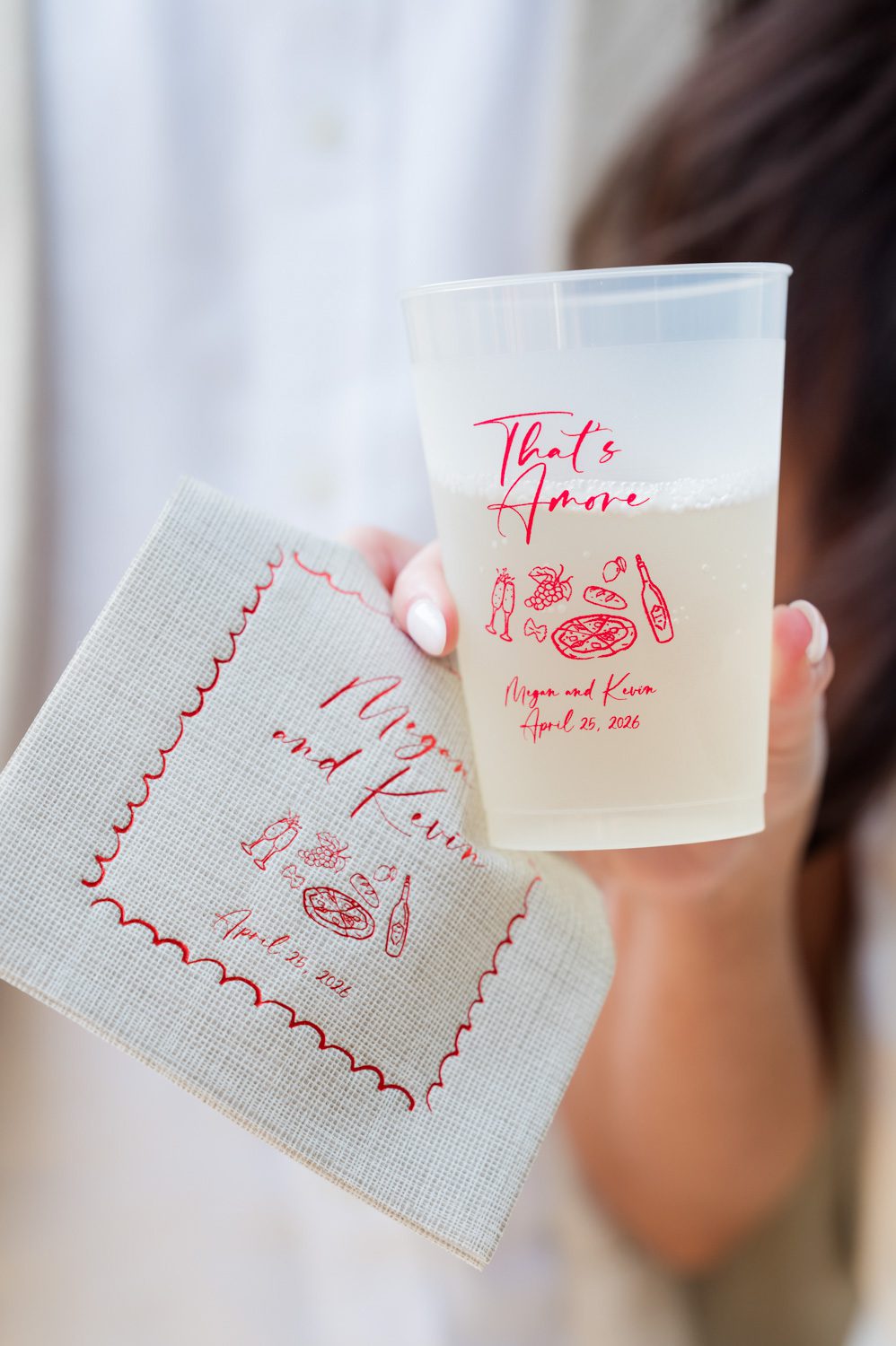 Close-up of personalized napkin and custom printed cup styled for an Italian-themed rehearsal dinner at Middleton Place Inn, featuring elegant tabletop details and curated celebration design.
