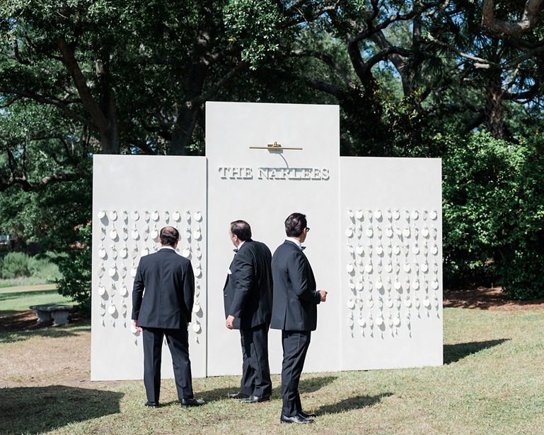 guests viewing large seating chart with tags at wedding reception at Lowndes Grove wedding reception