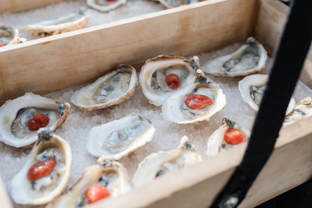 Oysters on the half shell on ice in a wooden box