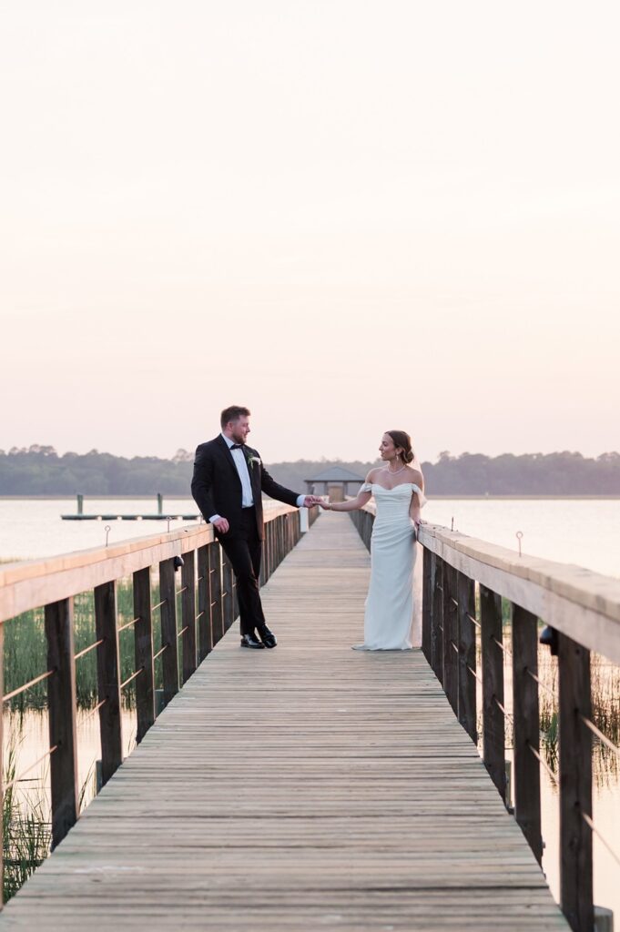 Sunset wedding portraits on the dock at Lowndes Grove wedding venue