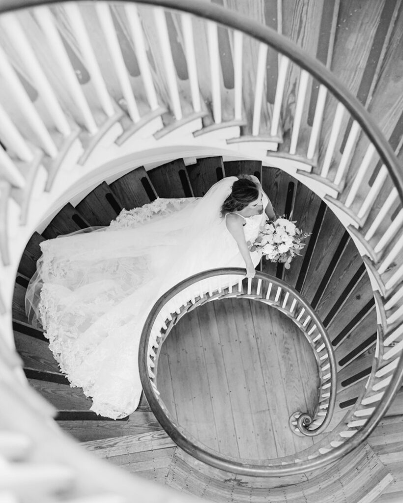 Bride walking down the spiral staircase at Lowndes Grove